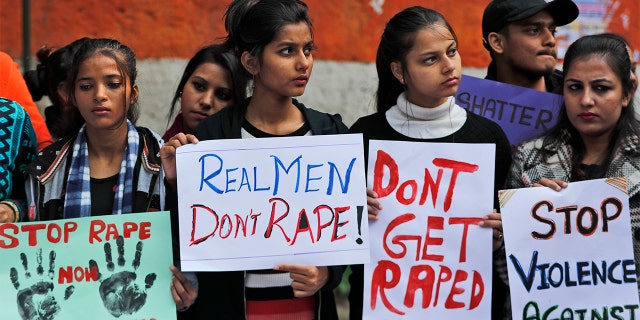 Women activists hold banners and participate in a protest demanding justice in the case of a veterinarian who was gang-raped and killed last week, in New Delhi, India, Tuesday, Dec. 3, 2019. (AP Photo/Manish Swarup)