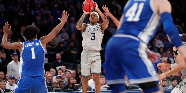 Georgetown guard James Akinjo (3) shoots during the second half as Duke center Vernon Carey Jr. (1) defends during the second half of an NCAA college basketball game in the 2K Empire Classic, Friday, Nov. 22, 2019 in New York. Duke won 81-73. (AP Photo/Kathy Willens)