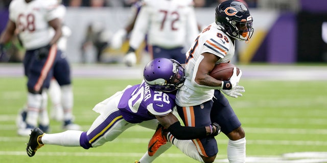 Chicago Bears wide receiver Javon Wims, right, tries to break a tackle by Minnesota Vikings cornerback Mackensie Alexander, left, after catching a pass during the first half of an NFL football game, Sunday, Dec. 29, 2019, in Minneapolis. (AP Photo/Andy Clayton-King)