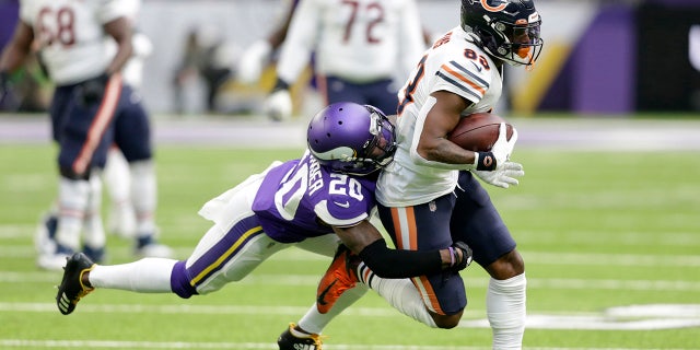 Chicago Bears wide receiver Javon Wims, right, tries to break a tackle by Minnesota Vikings cornerback Mackensie Alexander, left, after catching a pass during the first half of an NFL football game, Sunday, Dec. 29, 2019, in Minneapolis. (AP Photo/Andy Clayton-King)
