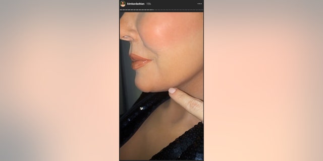 Kim Kardashian points out facial markings on mother Kris Jenner's wax replica.