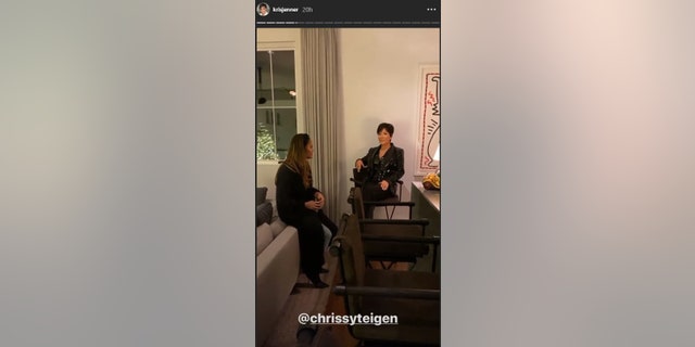Chrissy Teigen examines a wax replica of Kris Jenner.