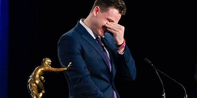 NCAA college football player, LSU quarterback Joe Burrow reacts while speaking after being awarded the Heisman Trophy, Saturday, Dec. 14, 2019, in New York. (Todd Van Emst/Pool Photo via AP)