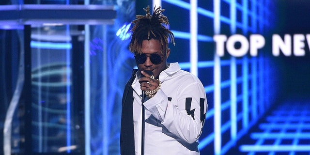 FILE - In this May 1, 2019 file photo, Juice WRLD accepts the award for top new artist at the Billboard Music Awards at the MGM Grand Garden Arena in Las Vegas. The Chicago-area rapper, whose real name is Jarad A. Higgins, was pronounced dead Sunday, Dec. 8 after a 