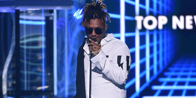 FILE - In this May 1, 2019 file photo, Juice WRLD accepts the award for top new artist at the Billboard Music Awards at the MGM Grand Garden Arena in Las Vegas. The Chicago-area rapper, whose real name is Jarad A. Higgins, was pronounced dead Sunday, Dec. 8 after a