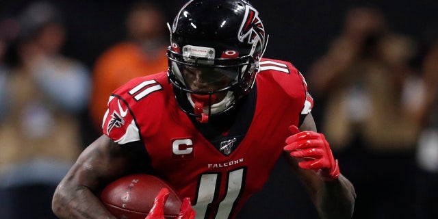 Atlanta Falcons wide receiver Julio Jones (11) runs by Jacksonville Jaguars cornerback A.J. Bouye (21) during the second half of an NFL football game, Sunday, Dec. 22, 2019, in Atlanta. (AP Photo/John Bazemore)