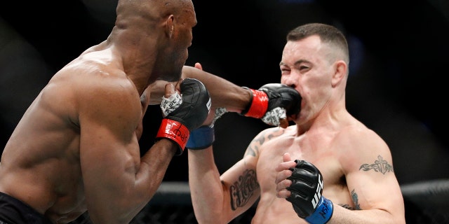 Kamaru Usman hits Colby Covington in a mixed martial arts welterweight championship bout at UFC 245, Saturday, Dec. 14, 2019, in Las Vegas. (AP Photo/John Locher)