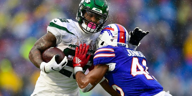 A Buffalo Bills defender tackles New York Jets running back Le'Veon Bell (26) during the first half of an NFL football game Sunday, Dec. 29, 2019 in Orchard Park, N.Y. (AP Photo/David Dermer)