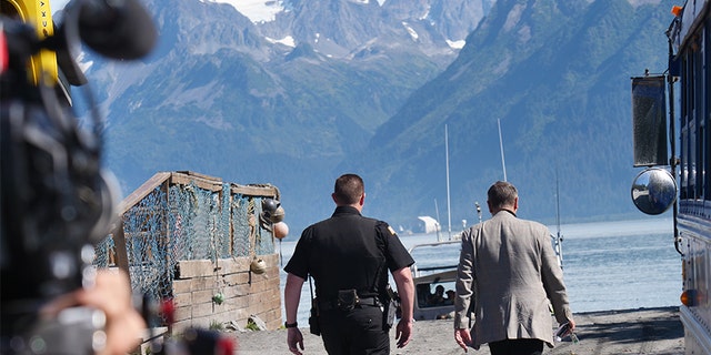 Frank Parlato and Lt. Nickell walking down towards the harbor. Production crew included.