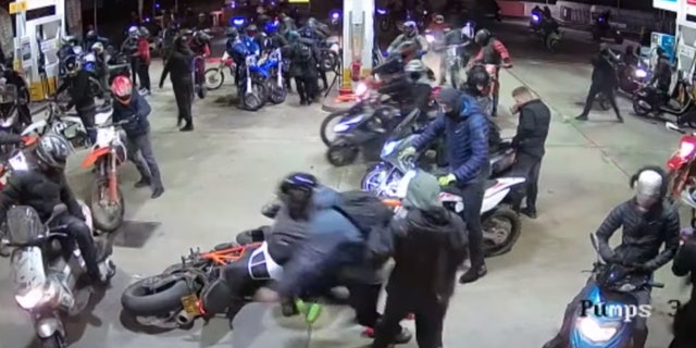 The large group of men on motorbikes swarmed a gas station on Halloween night.