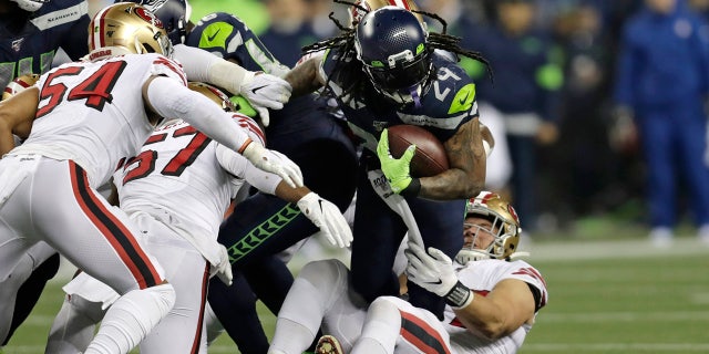 The Seattle Seahawks' Marshawn Lynch (24) carries on a fourth-and-1 but is pulled down short during the first half of a game against the San Francisco 49ers Dec. 29, 2019, in Seattle.