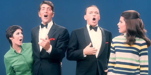 Dean Martin (1917-1995) and Frank Sinatra (1915-1998) sing with their daughters Deana Martin and Tina Sinatra during the taping of "The Dean Martin Variety Show" circa 1967 in Los Angeles, California.