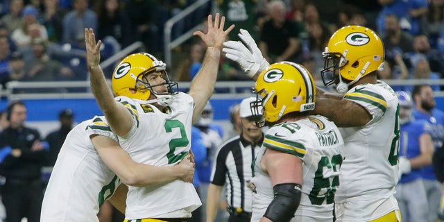 Green Bay Packers kicker Mason Crosby (2) is surrounded by teammates after making the winning field goal during the second half of an NFL football game against the Detroit Lions, Sunday, Dec. 29, 2019, in Detroit. (AP Photo/Duane Burleson)