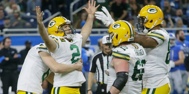 Green Bay Packers kicker Mason Crosby (2) is surrounded by teammates after making the winning field goal during the second half of an NFL football game against the Detroit Lions, Sunday, Dec. 29, 2019, in Detroit. (AP Photo/Duane Burleson)