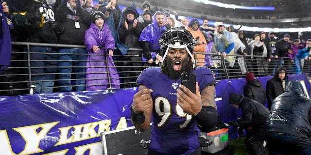 Baltimore Ravens outside linebacker Matt Judon (99) reacts while holding a smartphone after an NFL football game against the Pittsburgh Steelers, Sunday, Dec. 29, 2019, in Baltimore. The Ravens won 28-10. (AP Photo/Nick Wass)