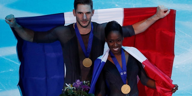 France's Vanessa James and Morgan Cipres celebrate first place in the Pairs Free Skating.