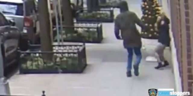 The suspect can be seen swinging at a 21-year-old woman who was on her phone.