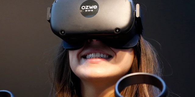 A visitor tries a virtual reality helmet Oculus Quest during the Virtuality Paris 2019 show on November 21, 2019 in Paris, France - file photo.