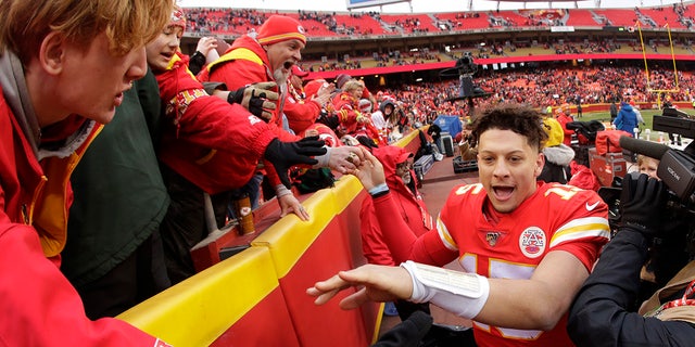 Kansas City Chiefs quarterback Patrick Mahomes (15) celebrates with fans after an NFL football game against the Los Angeles Chargers, Sunday, Dec. 29, 2019, in Kansas City, Mo. (AP Photo/Charlie Riedel)