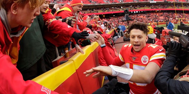 Kansas City Chiefs quarterback Patrick Mahomes (15) celebrates with fans after an NFL football game against the Los Angeles Chargers, Sunday, Dec. 29, 2019, in Kansas City, Mo. (AP Photo/Charlie Riedel)