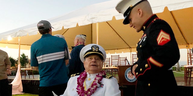 Marine Cpl. Zachariah Jeavons, 22, of Binghamton, N.Y., meets Pearl Harbor survivor Lou Conter, 98, who was aboard the USS Arizona when the Japanese attacked in 1941, Saturday, Dec. 7, 2019 at Pearl Harbor, Hawaii on the 78th anniversary of the attack. (AP Photo/Caleb Jones)