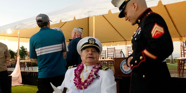 Marine Cpl. Zachariah Jeavons, 22, of Binghamton, N.Y., meets Pearl Harbor survivor Lou Conter, 98, who was aboard the USS Arizona when the Japanese attacked in 1941, Saturday, Dec. 7, 2019 at Pearl Harbor, Hawaii on the 78th anniversary of the attack. (AP Photo/Caleb Jones)