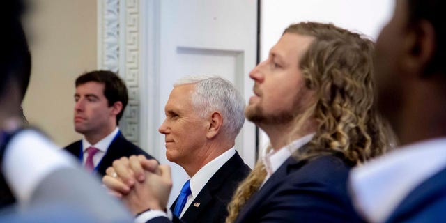 Vice President Mike Pence and Sean Feucht, a worship leader who is running for Congress in California, participate in a faith briefing at the White House complex Friday.