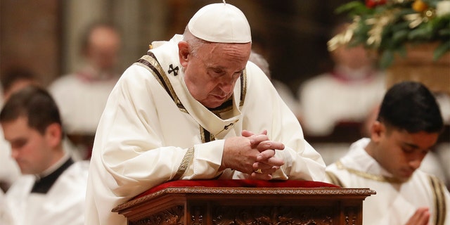 Pope Francis prays as he celebrates Christmas Eve Mass in St. Peter's Basilica at the Vatican, Tuesday, Dec. 24, 2019. (AP Photo/Alessandra Tarantino)