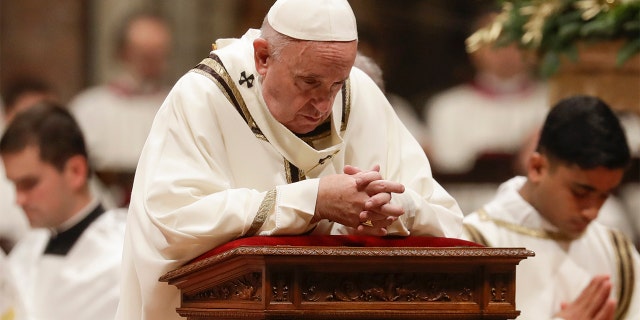 Pope Francis prays as he celebrates Christmas Eve Mass in St. Peter's Basilica at the Vatican, Tuesday, Dec. 24, 2019. (AP Photo/Alessandra Tarantino)