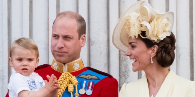 Prince William holds Prince Louis while Kate Middleton smiles in 2019.