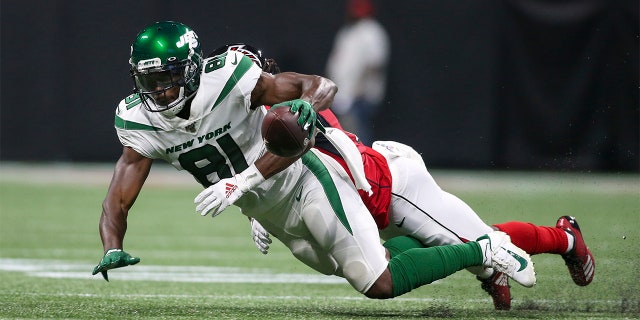 New York Jets wide receiver Quincy Enunwa (81) is tackled by Atlanta Falcons cornerback Desmond Trufant (21) in the second quarter at Mercedes-Benz Stadium.