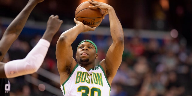 Boston Celtics forward Guerschon Yabusele (30) takes a contested three-point shot during the first quarter against the Washington Wizards at Capital One Arena.