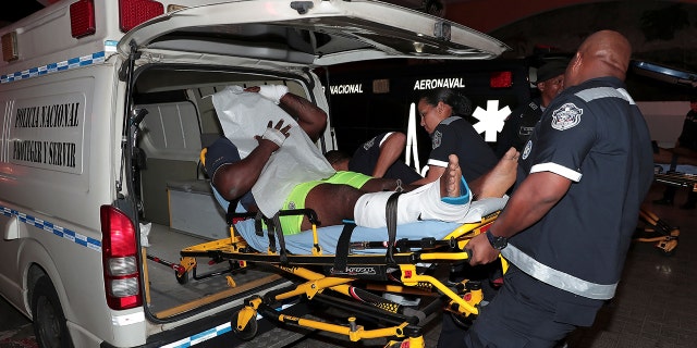 An injured inmate is carried on a stretcher into a hospital by police paramedics after a shootout among inmates at La Joyita jail, east of Panama City, Panama, on Tuesday. (Reuters)