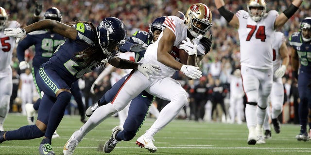 San Francisco 49ers' Raheem Mostert scores against the Seattle Seahawks during the second half of an NFL football game, Sunday, Dec. 29, 2019, in Seattle. (AP Photo/Ted S. Warren)