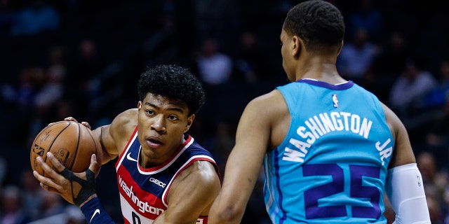 Washington Wizards forward Rui Hachimura, left, looks to drive against Charlotte Hornets forward P.J. Washington in the first half of an NBA basketball game in Charlotte, N.C., Tuesday, Dec. 10, 2019. (AP Photo/Nell Redmond)