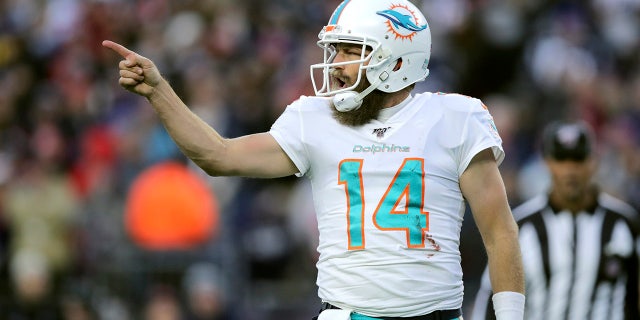 Miami Dolphins quarterback Ryan Fitzpatrick celebrates his winning touchdown pass to Mike Gesicki in the second half of an NFL football game against the New England Patriots, Sunday, Dec. 29, 2019, in Foxborough, Mass. (AP Photo/Charles Krupa)