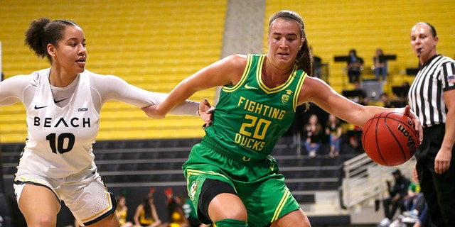 Oregon's Sabrina Ionescu (20) drives against Long Beach State's Justina King (10) in the first half of an NCAA college basketball game, Saturday, Dec. 14, 2094 in Long Beach, Calif. (AP Photo/Ringo H.W. Chiu)