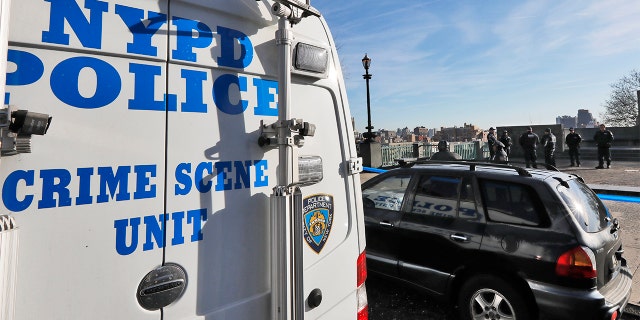 A New York City Police Dept. Crime Scene Unit and officers assemble at an entrance to Morningside Park along Manhattan's Upper West Side, on Dec. 12, 2019, in New York. An 18-year-old Barnard College freshman, identified as Tessa Majors, was fatally stabbed in the park, sending shock waves through the college and wider Columbia University community. (AP Photo/Richard Drew)