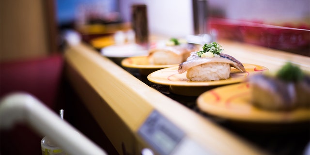 Conveyor belt sushi. Two men in Japan were arrested over a prank in which they dipped their chopsticks into a communal bowl. 