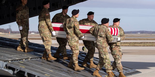 In this Dec. 25, 2019, file photo, an Army carry team moves a transfer case containing the remains of U.S. Army Sgt. 1st Class Michael Goble, at Dover Air Force Base, Del.. Goble, a U.S. Special Forces soldier who died in Afghanistan when he was seizing a Taliban weapons cache when he was killed, the U.S. military said Friday.