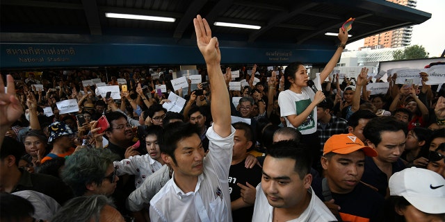 Thailand's Future Forward Party leader Thanathorn Juangroongruangkit gestures as he talks to his supporters during rally in Bangkok, Thailand, Saturday, Dec. 14, 2019. Several thousand supporters of a popular Thai political party, under threat of dissolution, packed a concourse in central Bangkok on Saturday in one of the largest political demonstrations in recent years. (AP Photo/Str)