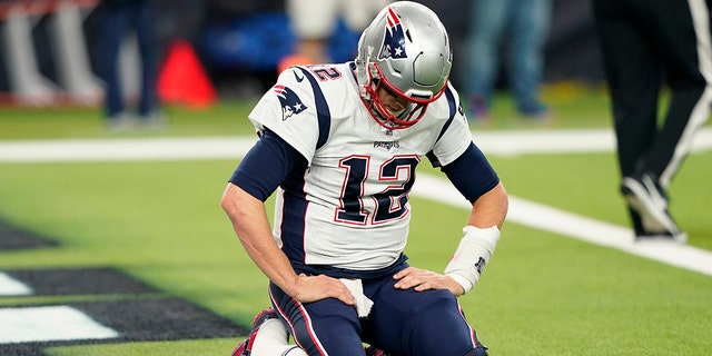 New England Patriots quarterback Tom Brady (12) kneels on the turn after a play during the second half of an NFL football game against the Houston Texans Sunday, Dec. 1, 2019, in Houston. (AP Photo/David J. Phillip)