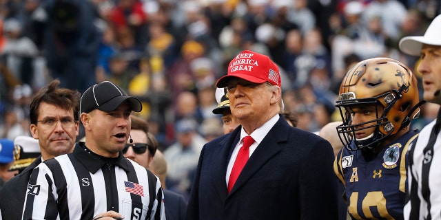 President Donald Trump waits for the coin toss before the start of the Army-Navy college football game in Philadelphia, Saturday, Dec. 14, 2019. (AP Photo/Jacquelyn Martin)