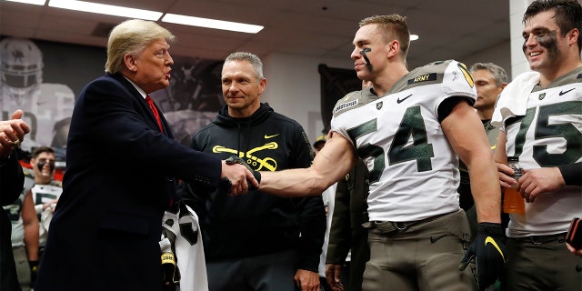 President Donald Trump shakes hands with Army player Cole Christiansen in Philadelphia, Saturday, Dec. 14, 2019, before the Army-Navy college football game. (AP Photo/Jacquelyn Martin)