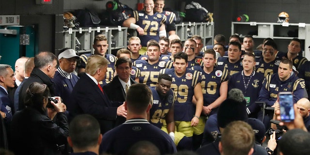 President Donald Trump greets the Navy football team in Philadelphia, Saturday, Dec. 14, 2019, before the Army-Navy college football game. (AP Photo/Jacquelyn Martin)