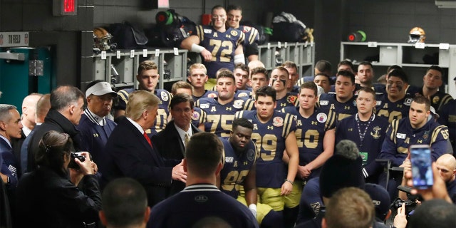 President Donald Trump greets the Navy football team in Philadelphia, Saturday, Dec. 14, 2019, before the Army-Navy college football game. (AP Photo/Jacquelyn Martin)