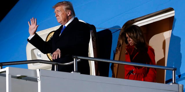 U.S. President Donald Trump waves as he and U.S. first lady Melania Trump arrive at Stansted Airport in England, Monday, Dec. 2, 2019. US President Donald Trump will join other NATO heads of state at Buckingham Palace in London on Tuesday to mark the NATO Alliance's 70th birthday. (AP Photo/Evan Vucci)