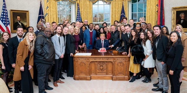 President Trump surrounded by a large group of worship leaders from across the country whom he invited to pray for him in the Oval Office Friday.