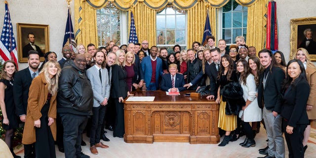 President Trump surrounded by a large group of worship leaders from across the country whom he invited to pray for him in the Oval Office Friday.