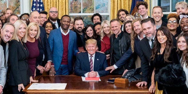 President Trump surrounded by a large group of worship leaders from across the country whom he invited to pray for him in the Oval Office Friday.